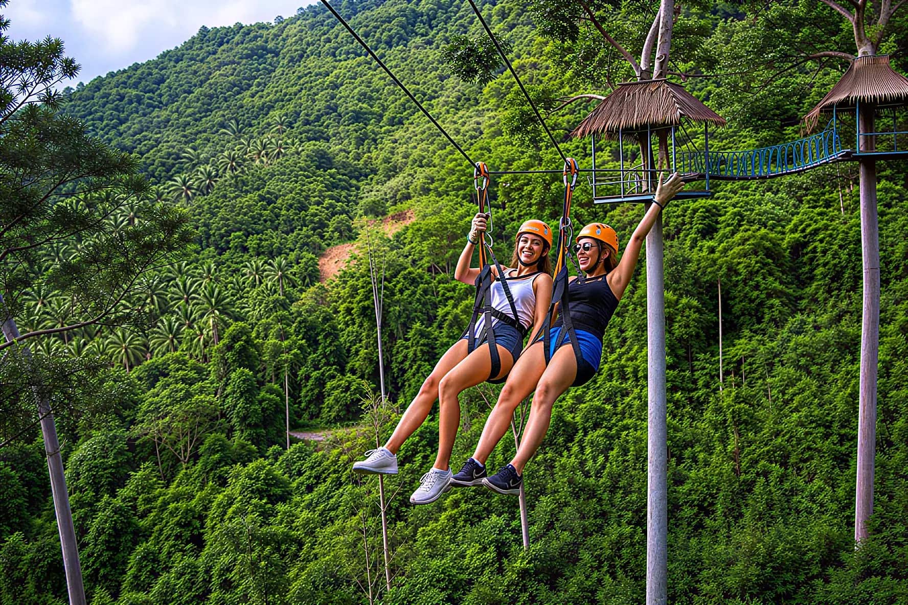 Two friends ziplining side by side over the jungle hills of Koh Samui