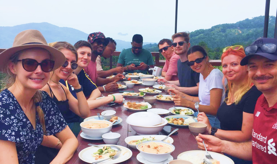 Visitors dining at a mountain-top restaurant with expansive views during a Samui excursion