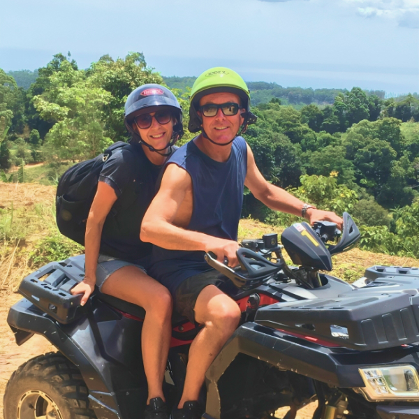 Tourists enjoying their private ATV ride, overlooking the ocean from Samui's mountainous terrain