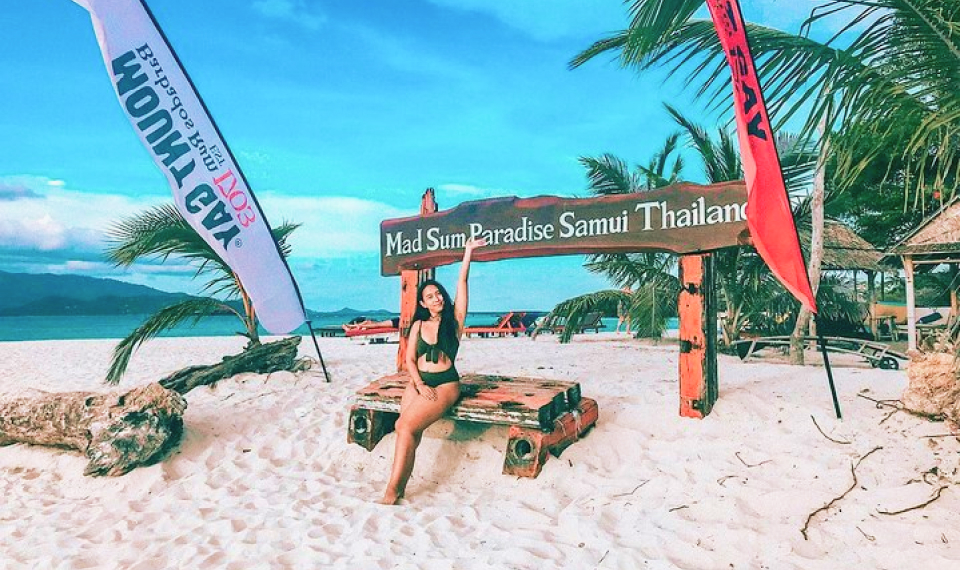 Visitor relaxing at the Madsum Island signpost, a serene destination on Samui island excursions