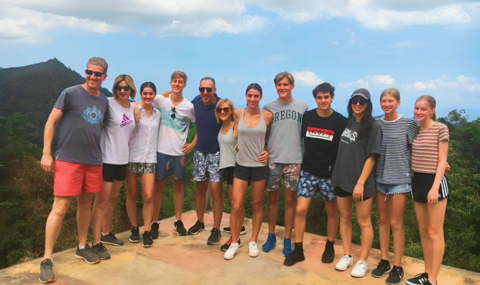 Happy tourists posing with the panoramic hills backdrop, after a thrilling ATV Samui tour adventure