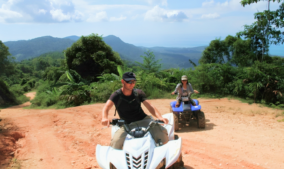 ATV riders pausing to admire the view of Samui's lush forests